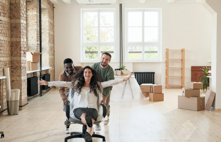 Excited colleagues having fun in empty office